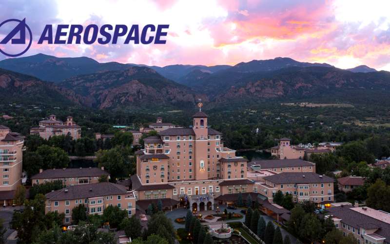 The Aerospace Logo above an aerial image of the Broadmoor Hotel in Colorado Springs.