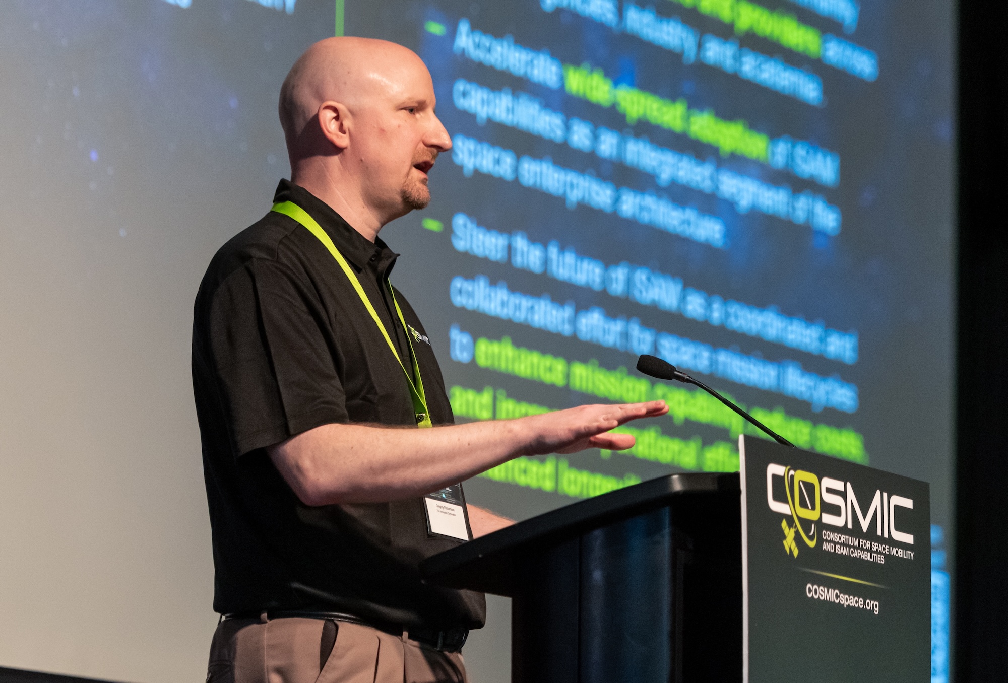 COSMIC executive director Greg Richardson at a podium.