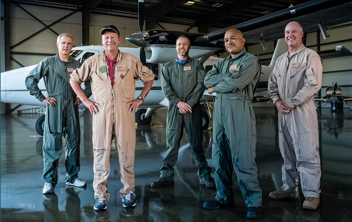 Image of group in a airplane hanger