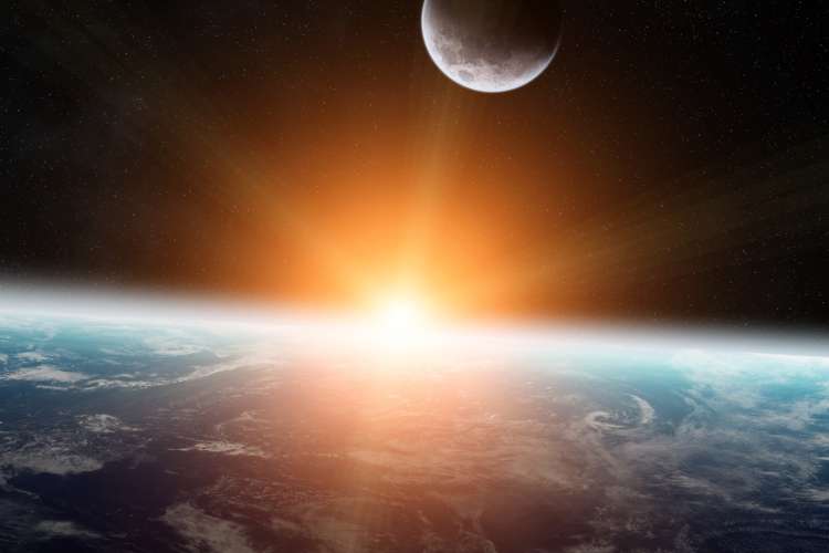 Sun rising on a zoomed out shot of Earth