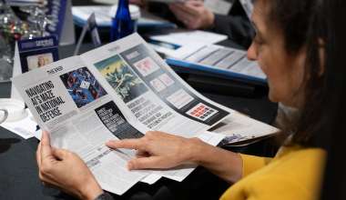 Aerospace COO Tanya Pemberton looks over game materials at a DC riskgaming exercise