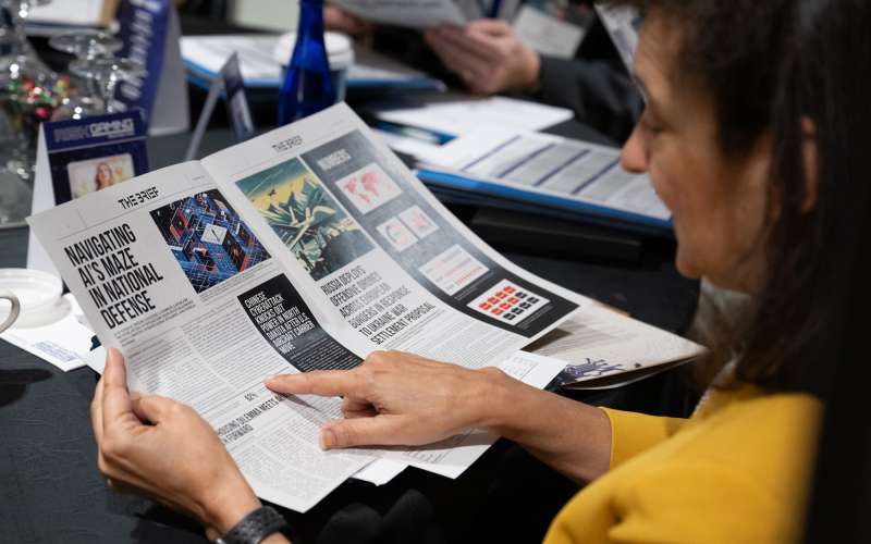 Aerospace COO Tanya Pemberton looks over game materials at a DC riskgaming exercise